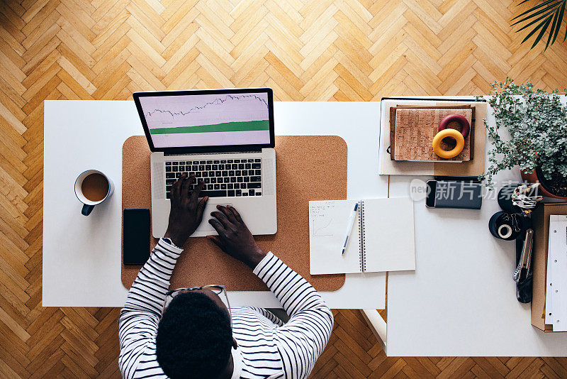 Table Top View Of Unrecognizable BusinessmanÂ Working At Home On A Laptop Computer